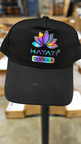 Black cap with colorful logo and text on a white surface